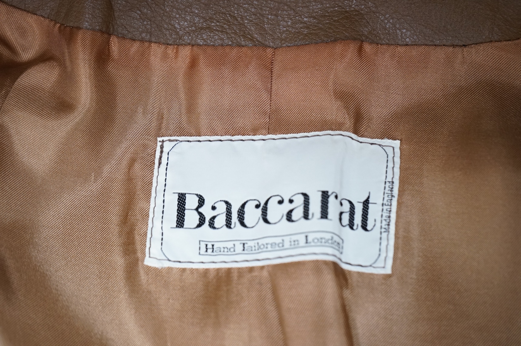 A Baccarat tan leather jacket and a black close-fitting Korean leather jacket size 10